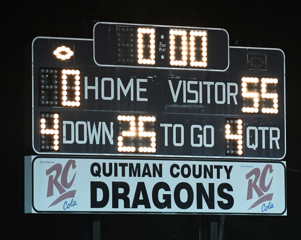 A scoreboard with "QUITMAN COUNTY DRAGONS" below. It shows 0:00, 0 for home, 55 for visitors, 4 down, 25 to go, 4 QTR.