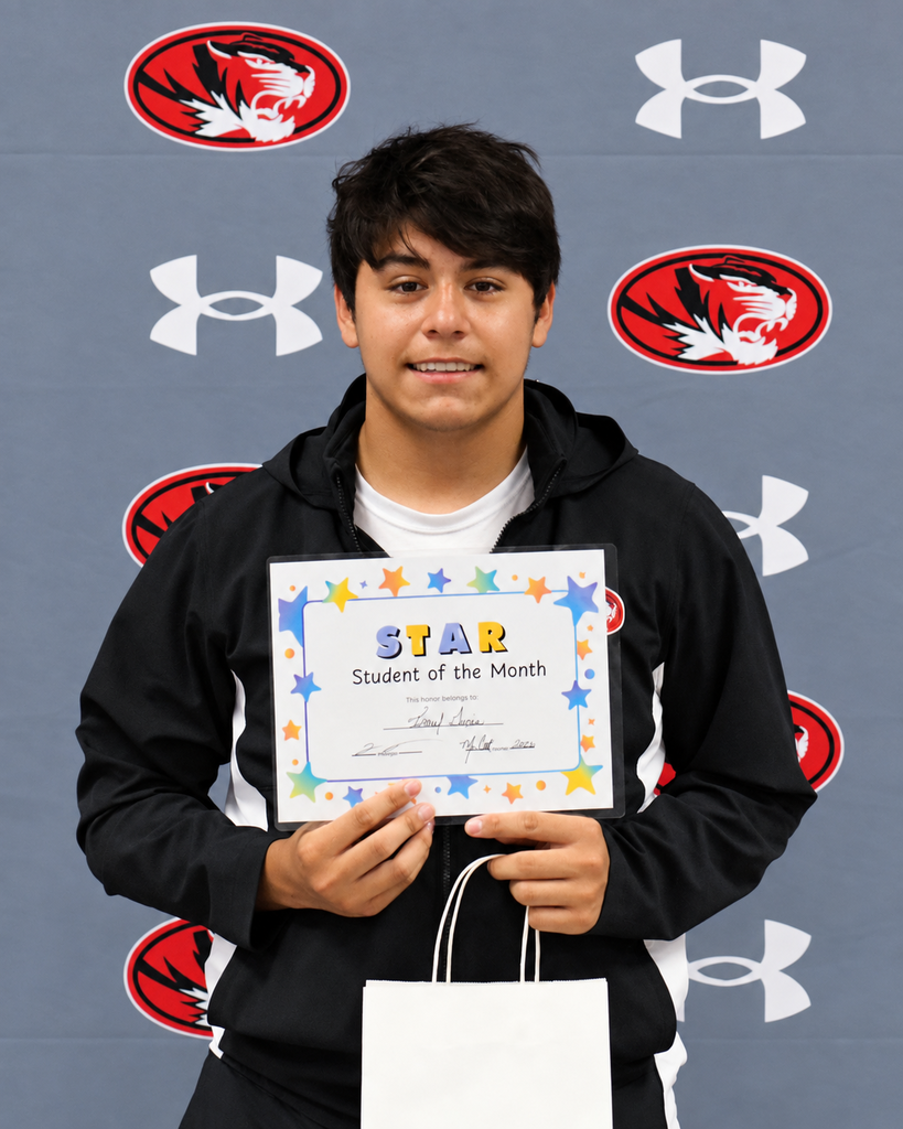 A young man holds a certificate reading "STAR Student of the Month" in front of a wall with logos.