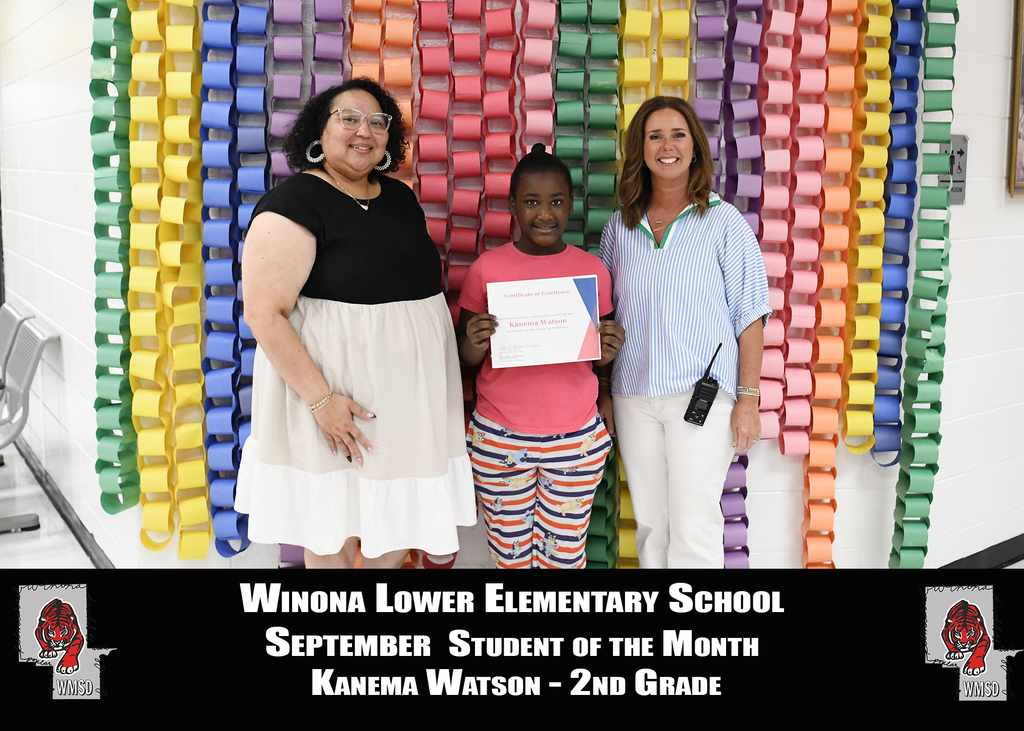 Three women, one holding a certificate, stand before a colorful backdrop. The central figure is a girl with a certificate. Text reads: "Winona Lower Elementary School SEPTEMBER STUDENT OF THE MONTH Kanema Watson - 2nd Grade".