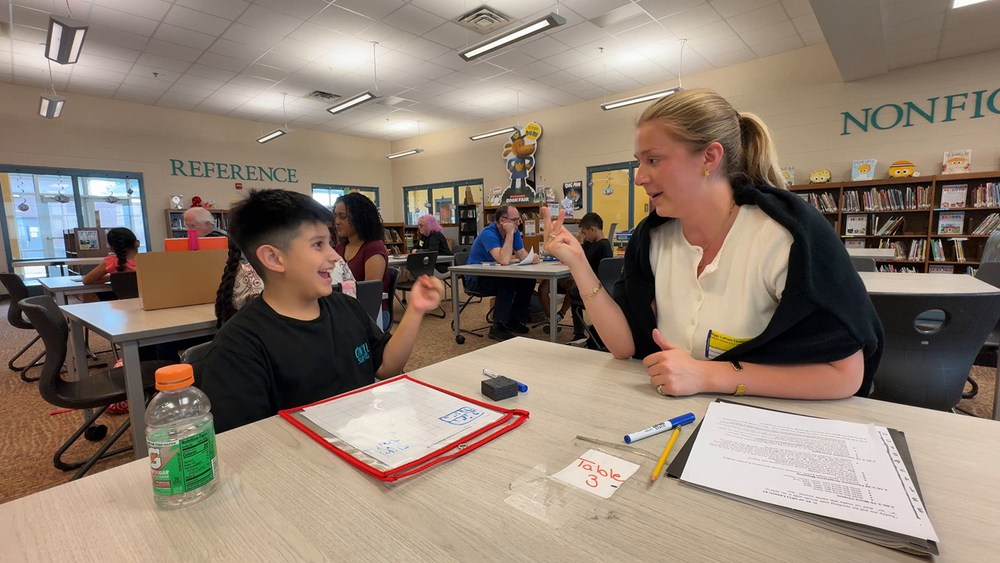 image of volunteers reading to students