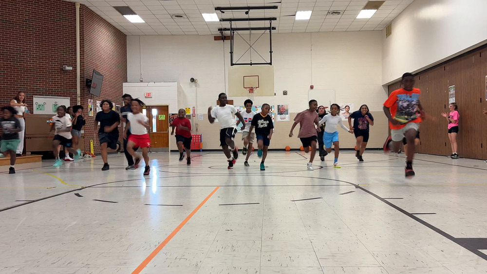 Griffith students running in gymnasium