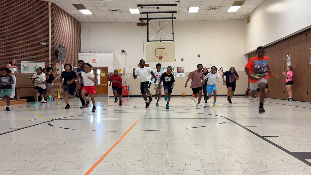 Griffith students running in gymnasium