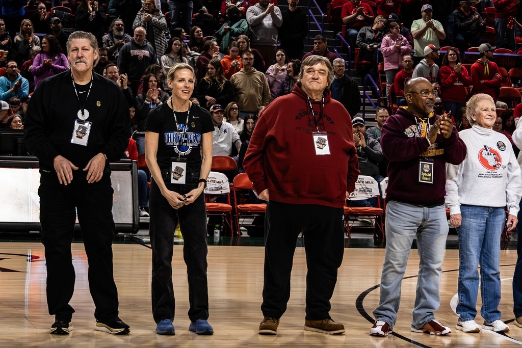 Coach Alberson (center/maroon sweater)