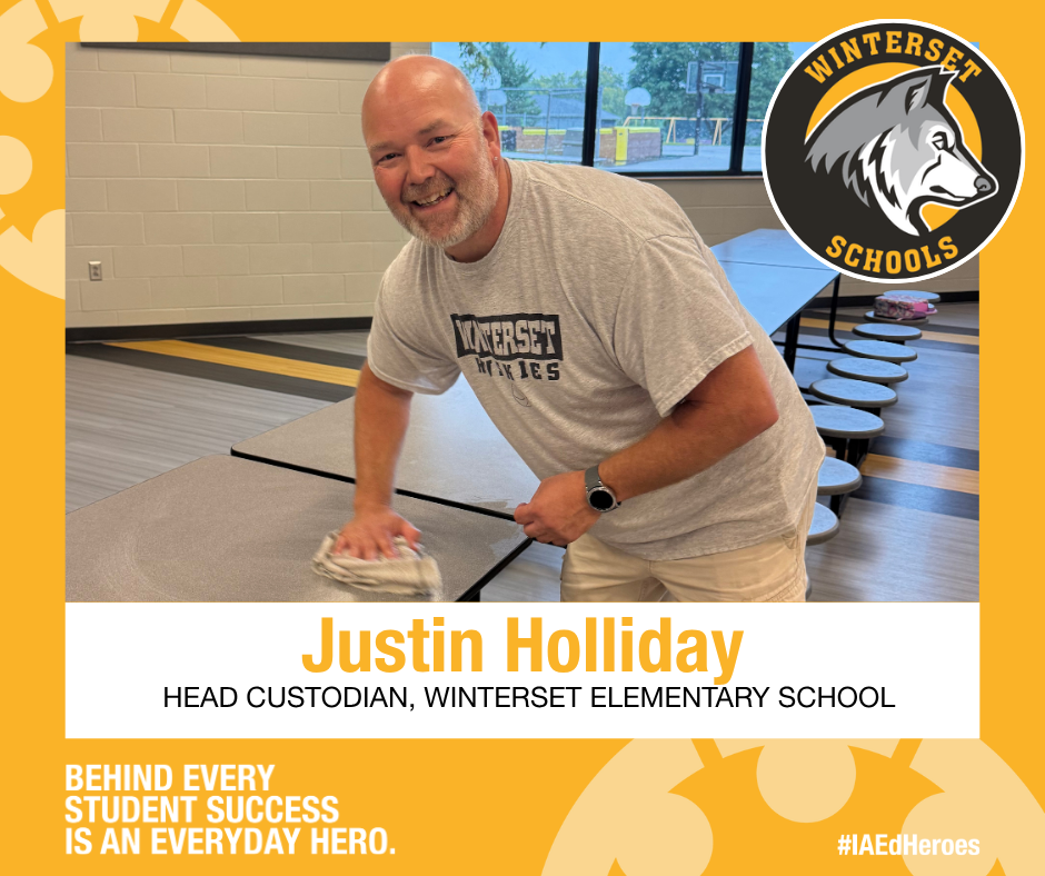A man in a gray t-shirt cleaning a table. A Winterset Schools logo is in the top right corner.