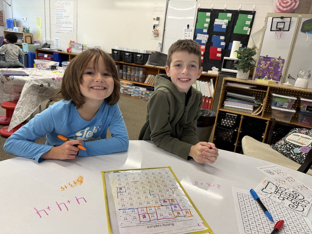 2 stuents with a squares chart in front of them