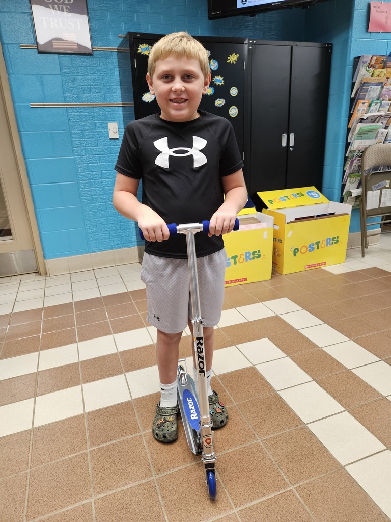 Photo of Cole Bumgarner on a scooter that he won at school