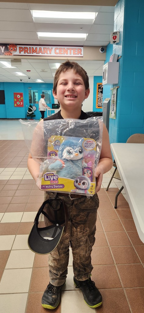Photo of Aiden Delong with Pet Penguin raffle prize