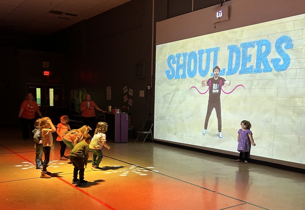 Photo of prek students following along with an activity on the Lu interactive wall