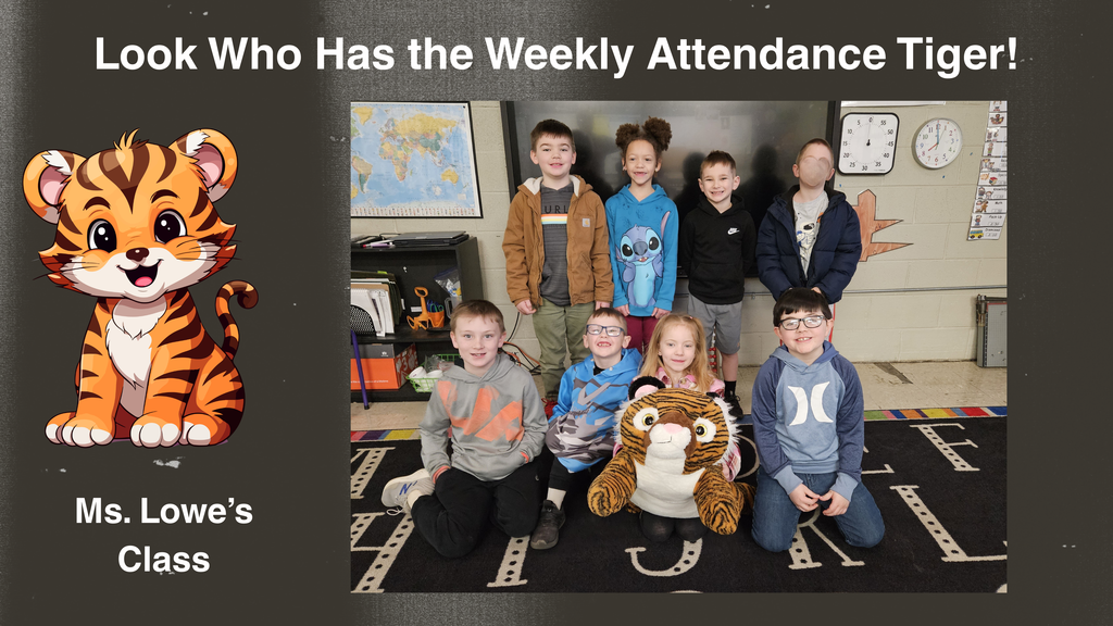 A classroom photo shows a group of students from Ms. Lowe’s class gathered together for a picture. Some students are standing and others are seated on a black rug with colorful trim. In front of the group is a large stuffed tiger, known as the Attendance Tiger. To the left of the photo in the graphic, there is an illustrated cartoon tiger and the text ‘Ms. Lowe’s Class.’ At the top of the graphic, text reads, ‘Look Who Has the Weekly Attendance Tiger!’ The setting includes classroom furniture, a world map on the wall, and a clock.