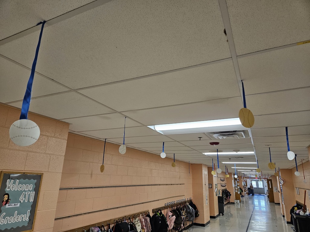 Hallway bulletin boards and classroom doors decorated with a baseball theme, featuring colorful signs, student names, and encouraging test‑taking messages such as “Cover Your Bases,” “Swing for the Fences,” and “Knock It Out of the Park” to motivate students for upcoming assessments.
