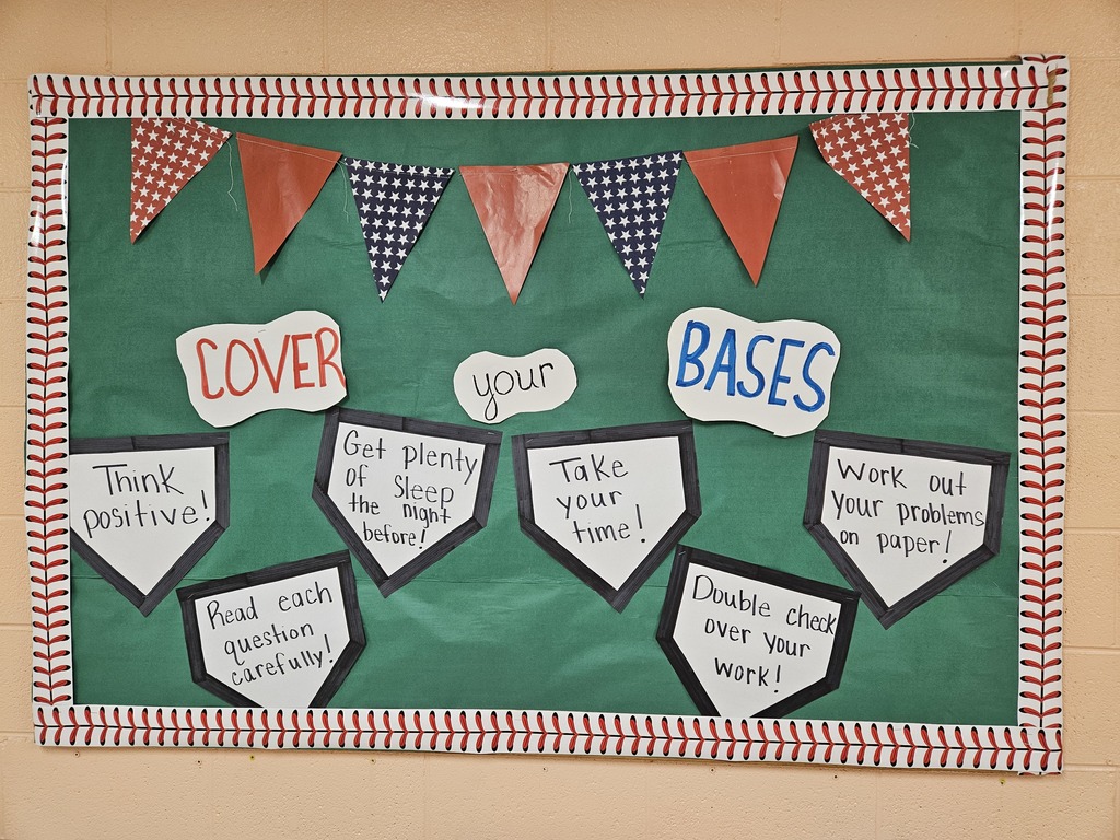 Hallway bulletin boards and classroom doors decorated with a baseball theme, featuring colorful signs, student names, and encouraging test‑taking messages such as “Cover Your Bases,” “Swing for the Fences,” and “Knock It Out of the Park” to motivate students for upcoming assessments.