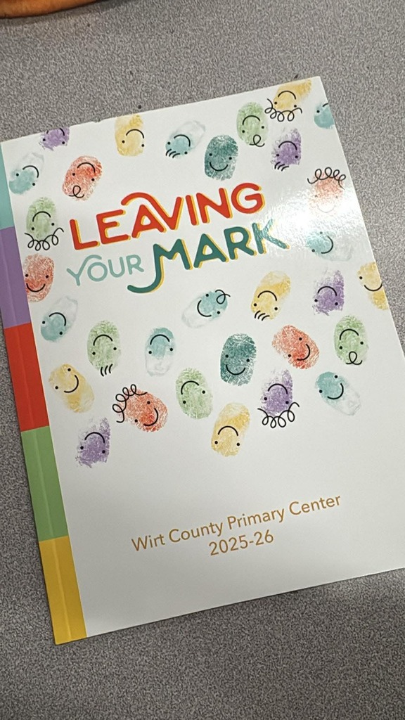 Cover of the Wirt County Primary Center 2025–26 yearbook titled “Leaving Your Mark.” The cover features colorful fingerprint illustrations with smiling faces scattered across a white background, with vertical color stripes along the left edge.