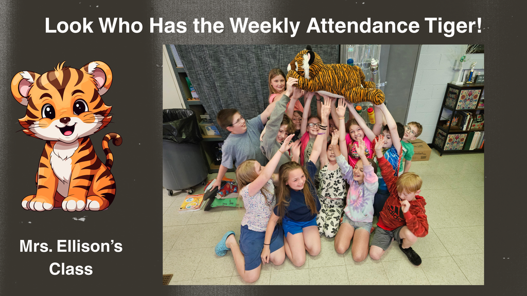 A group of approximately twelve elementary school students in a classroom kneel and stand closely together while raising a large stuffed tiger toy above their heads. The students are positioned on a tiled classroom floor with shelves and classroom materials visible in the background. To the left of the photo, a graphic illustration of a cartoon tiger appears. At the top of the image, large text reads “Look Who Has the Weekly Attendance Tiger!” and at the bottom left, text reads “Mrs. Ellison’s Class.”