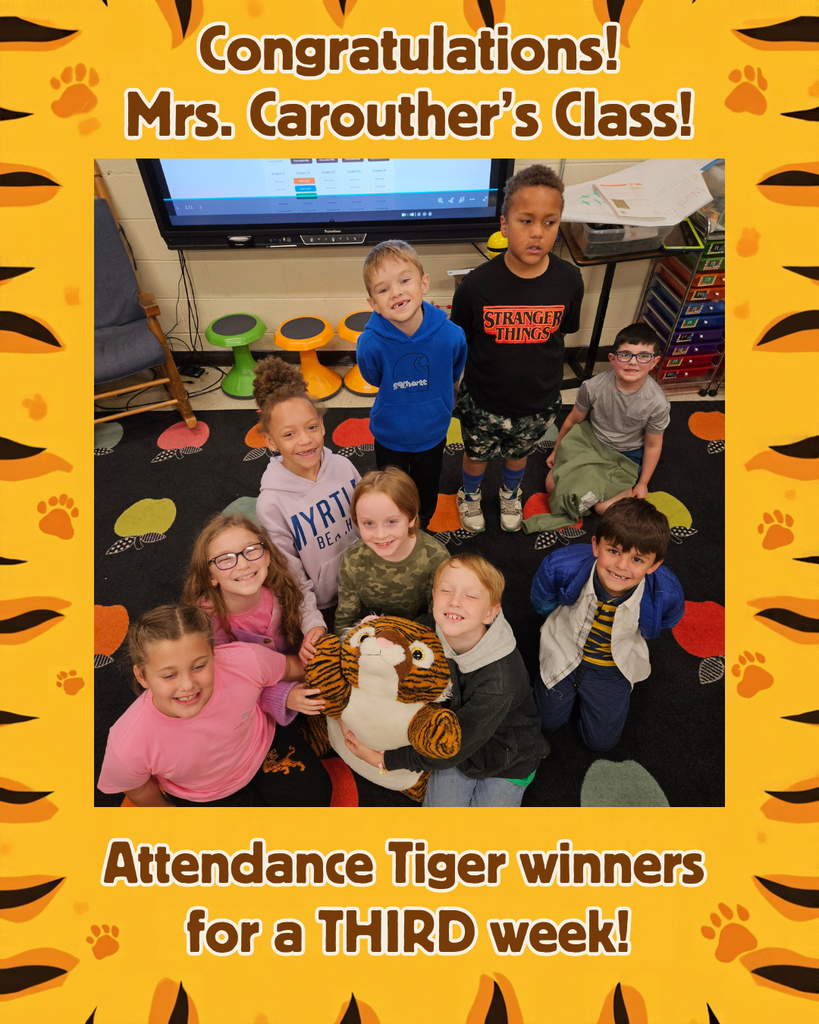 A group of elementary students from Mrs. Carouther’s Class pose together on a colorful classroom rug while holding an Attendance Tiger plush toy. A cheerful yellow and orange tiger-themed frame surrounds the photo, congratulating the class for winning the company of the Attendance Tiger for a third week.