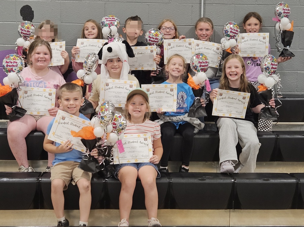 Group photo of students recognized during the first nine weeks Kindness Assembly at Wirt County Primary Center. Students are seated on gym bleachers holding Kindness Award certificates and balloon bouquets. The award recipients are gathered together for a commemorative photo celebrating their positive behavior, respect, and kindness shown throughout the school.