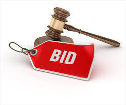 Picture of a gavel with a red tag that says Bid on it.