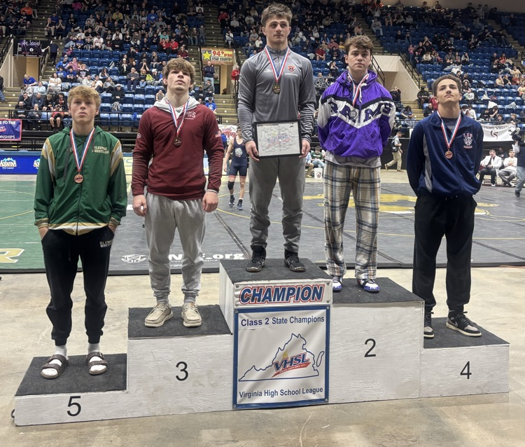Canaan S. stands on a podium.