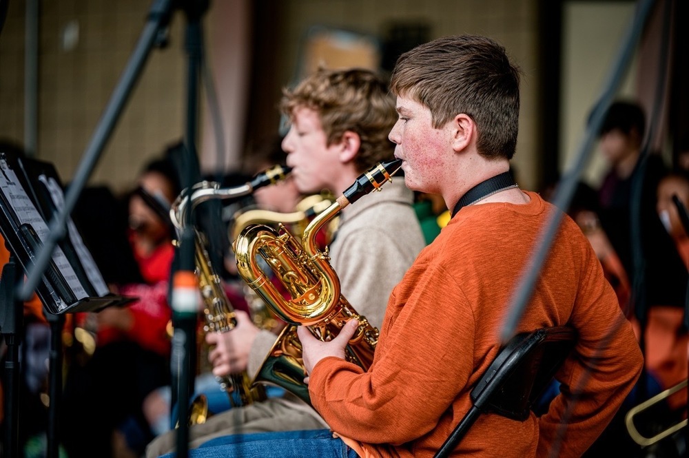 image of two boys playing a saxophone