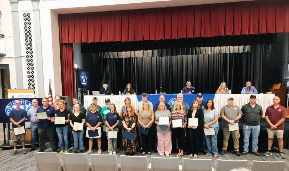 image of custodial and maintenance crews receiving honors at a board meeting