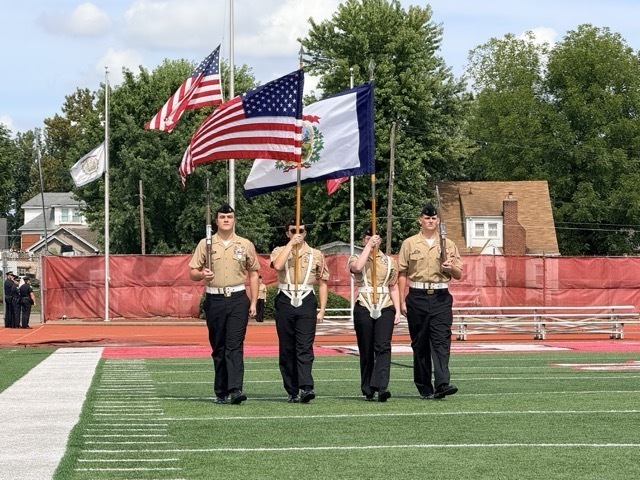 members of the PHS NJROTC carrying flags for ceremony