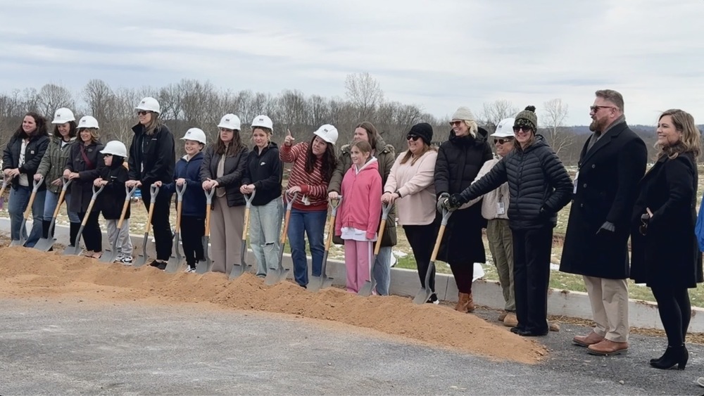 image of students and parents at the new Vienna Elementary Ground Breaking holding a shovel in front of dirt
