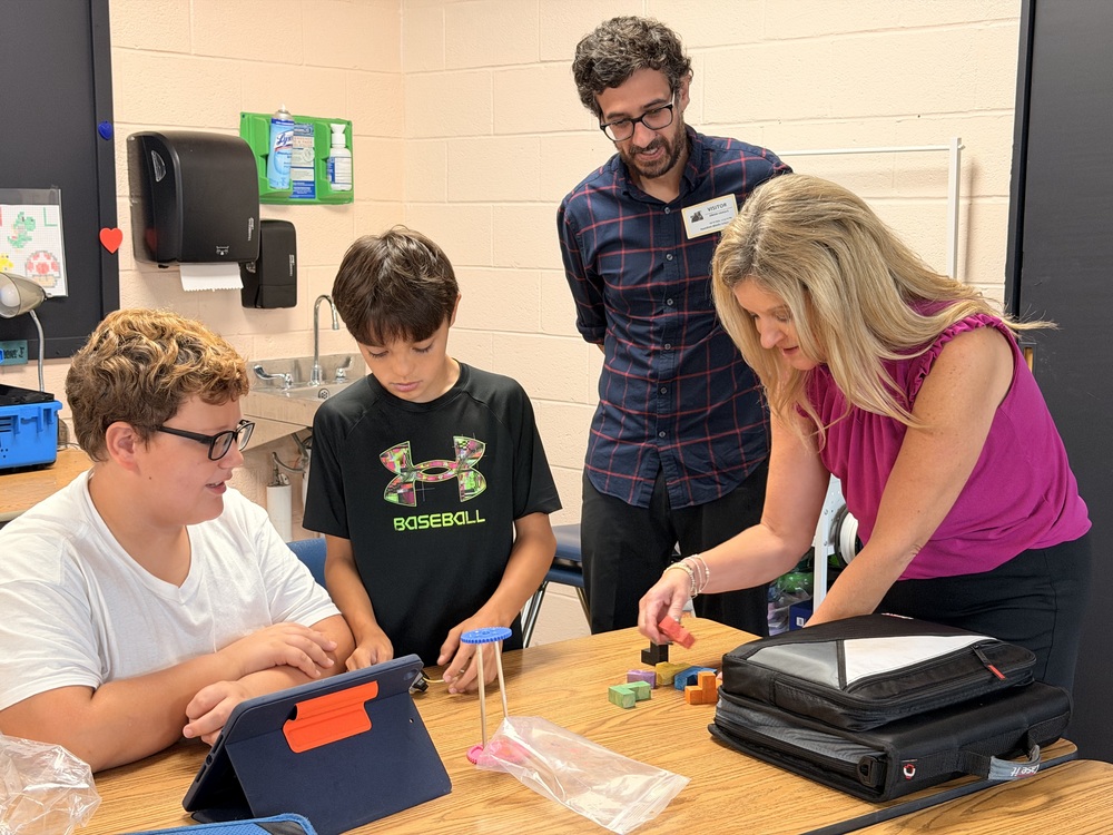 students and adults working on a challenge