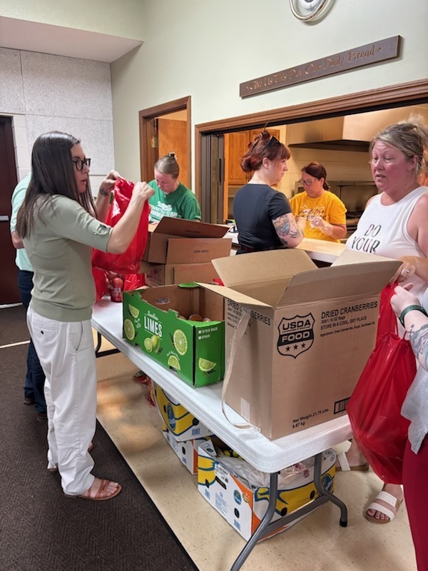 volunteers packing lunches for students