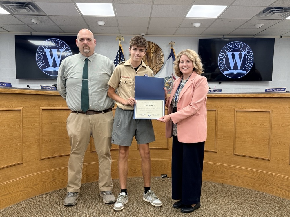 image featuring Jackson Middle School Principal, a student, and Wood County Schools Superintendent