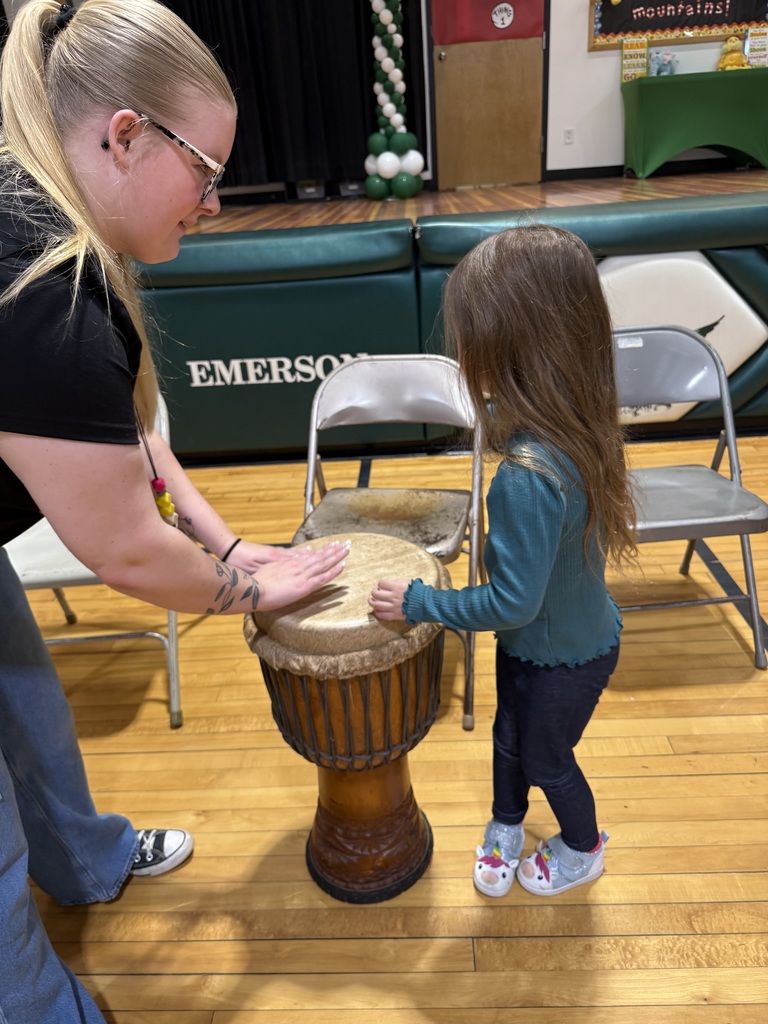 students and aide playing the drums