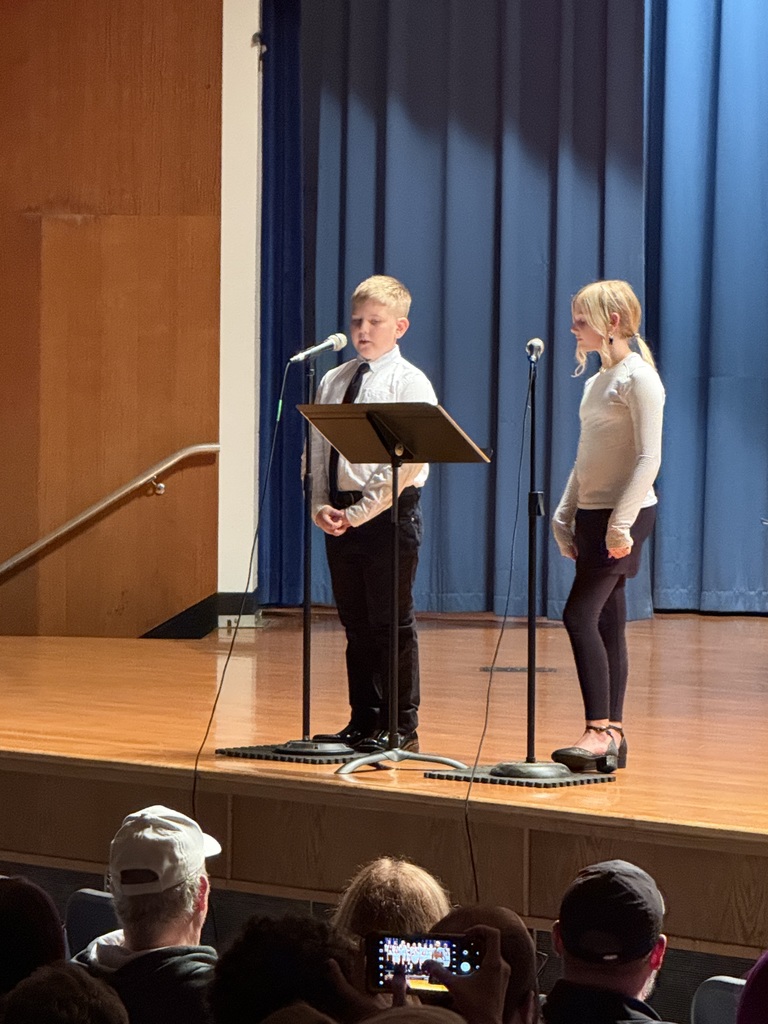 two students speaking on microphones