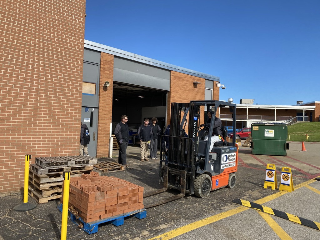 Image of student operating forklift.