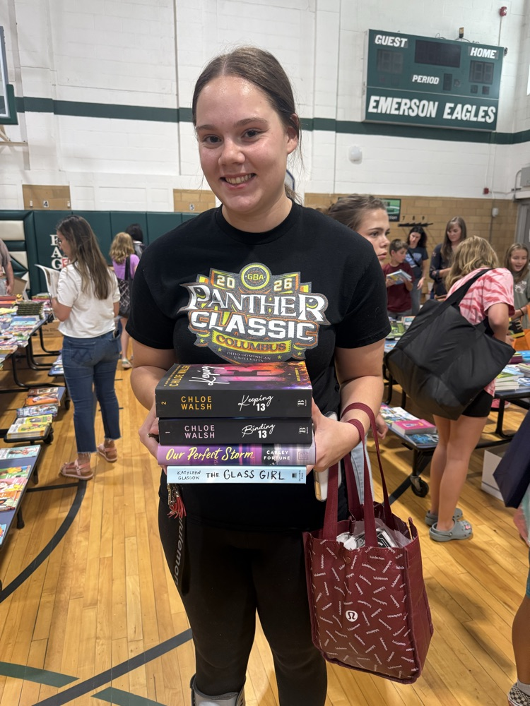 student holding books