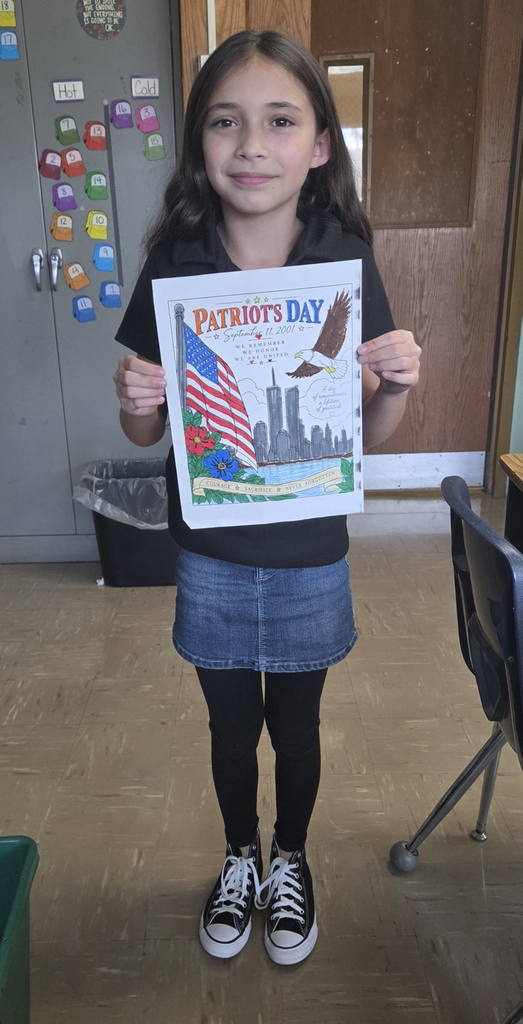 Student holding colored picture for Patriot Day