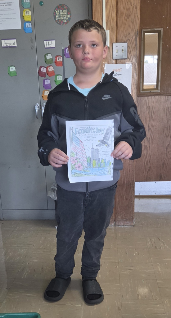 Student holding colored picture for Patriot Day