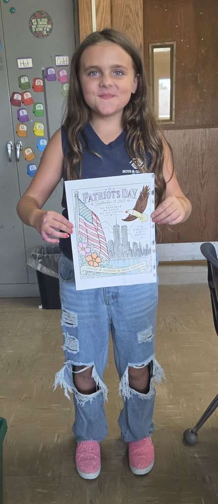 Student holding colored picture for Patriot Day