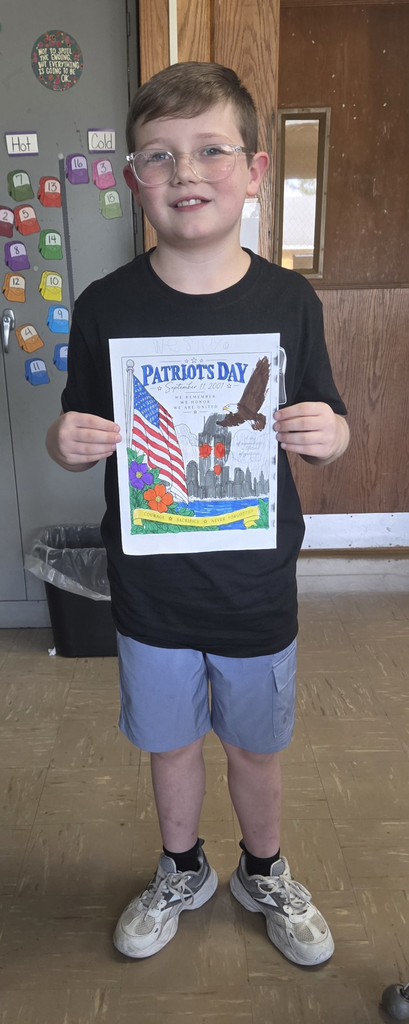 Student holding colored picture for Patriot Day