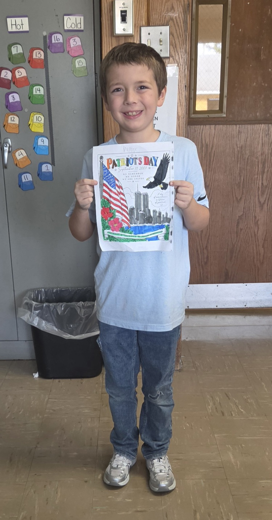 Student holding colored picture for Patriot Day