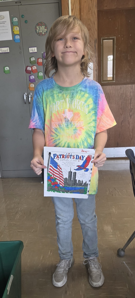 Student holding colored picture for Patriot Day