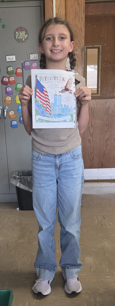 Student holding colored picture for Patriot Day