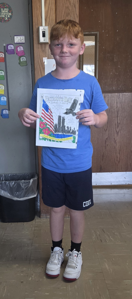 Student holding colored picture for Patriot Day