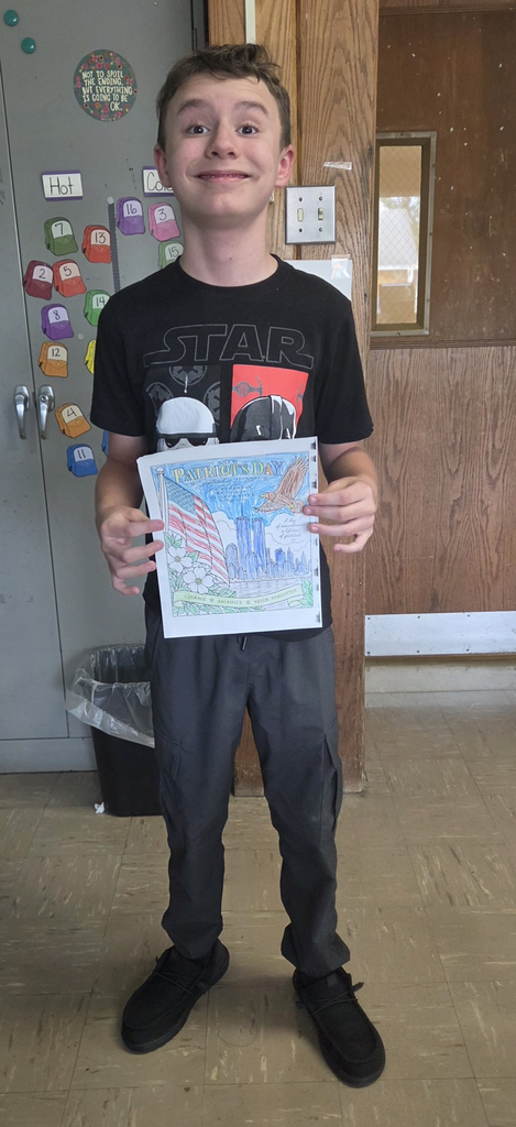 Student holding colored picture for Patriot Day