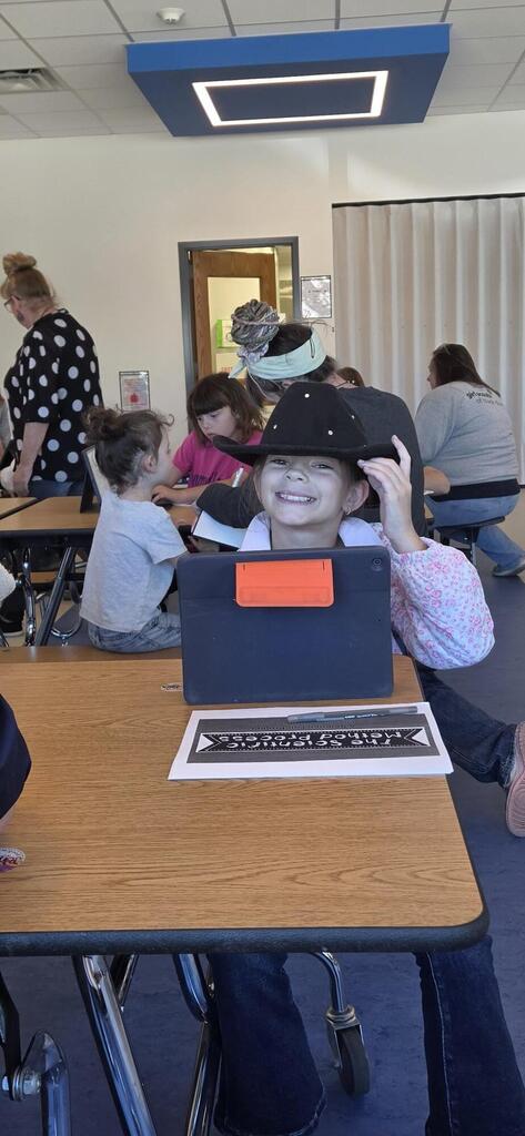 Girl smiling while she listens to the science fair presentation.
