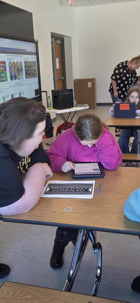 Teacher helping a student do science fair research.