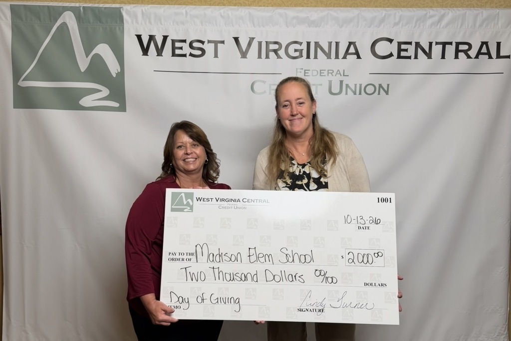 photo of Mrs. Plumly receiving grant check