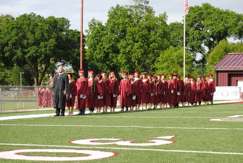 soon to be high school graduates entering stadium for graduation