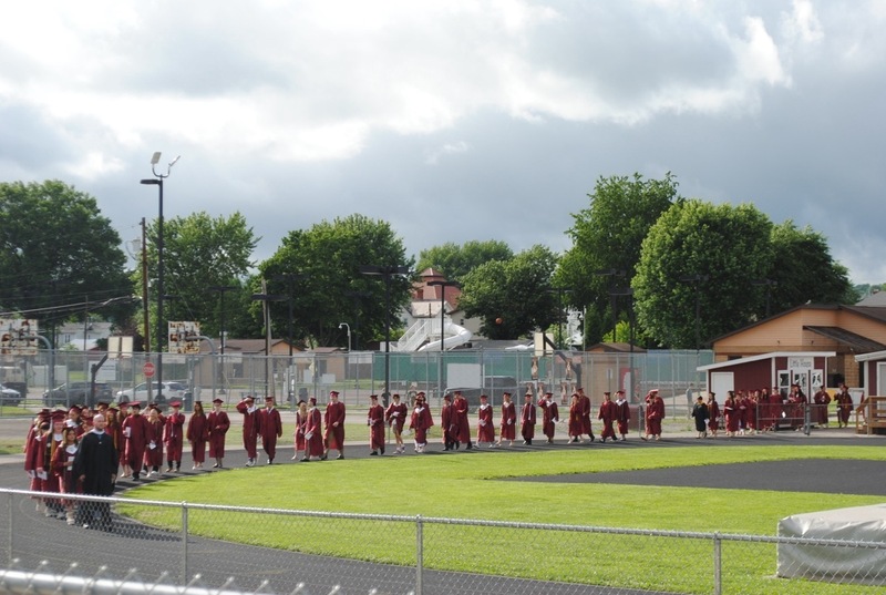 soon to be high school graduates lining up for graduation procession