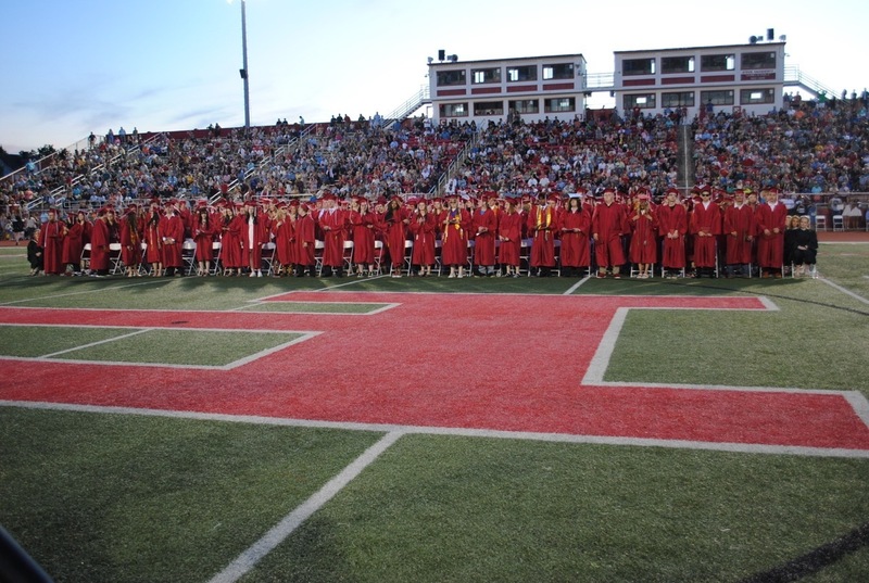 PHS graduates and crowd in background