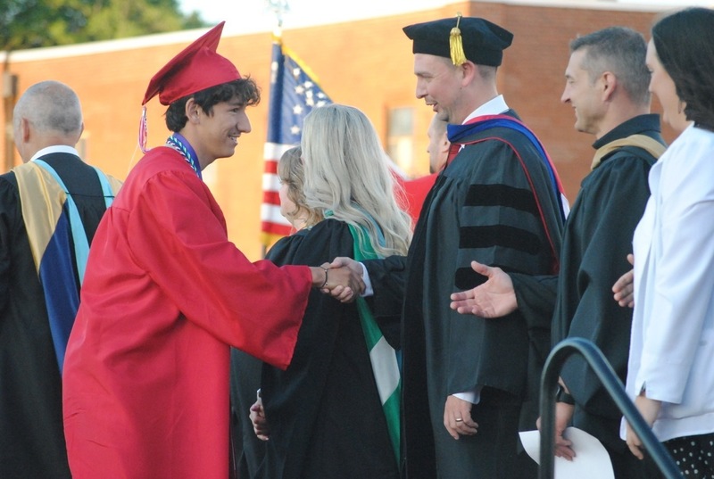 graduate shaking hands