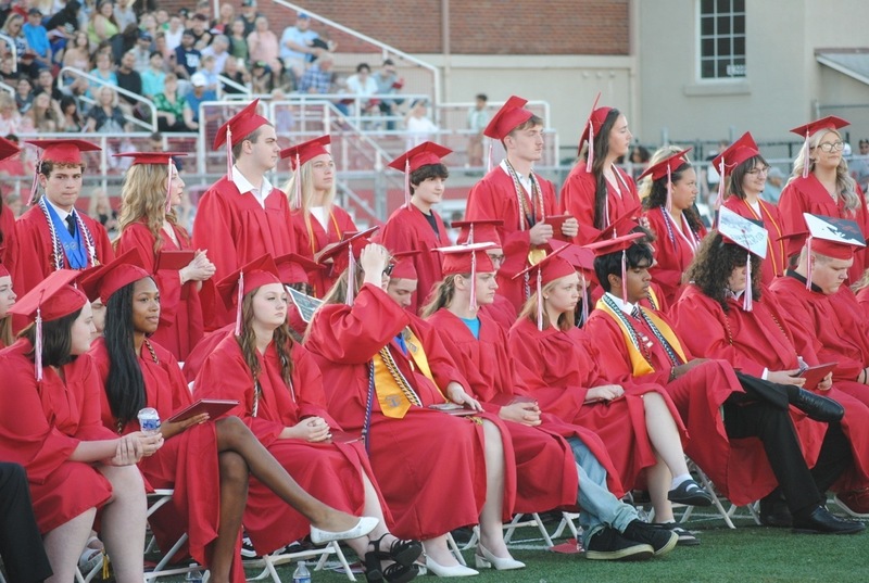 graduates lining up to get diplomas