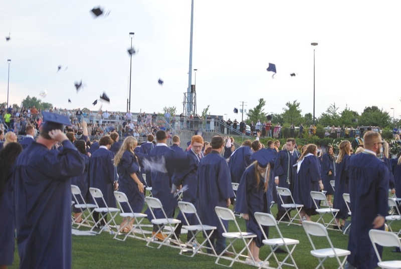 grads tossing caps at ceremony